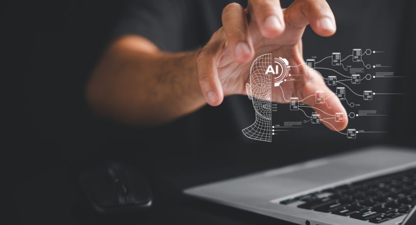 Mão tocando uma interface digital com ícone de cabeça e “AI”, representando inteligência artificial e fluxo de dados em frente a um laptop.